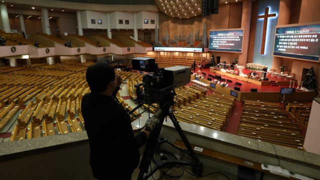A worker operates a camera for the live broadcast of a Christmas service being streamed online from Yoido Full Gospel Church as measures are taken to protect against the spread of coronavirus (COVID-19) on December 25, 2020 in Seoul, South Korea.