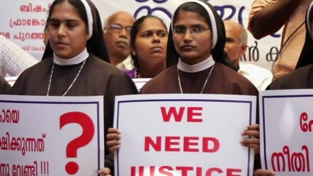 Nuns wearing plaques demanding justice