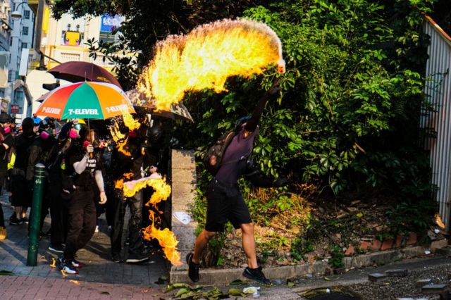 A protester throws a petrol bomb in Hong Kong