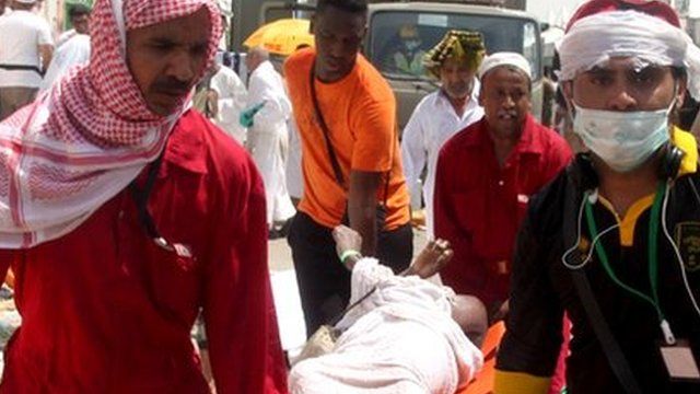 Saudi emergency personnel and Hajj pilgrims carry a wounded person
