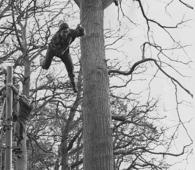 King Charles III tackles an assault course at the Royal Marines Training Centre in Lympstone, Devon, and achieves a first-class pass, 13 January 1975.