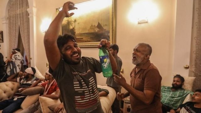 Protesters cheer inside the president's residence in Colombo