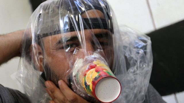 Hudhayfa al-Shahad tries an improvised gas mask in Idlib, Syria September 3, 2018