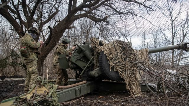 Members of the Ukrainian services prepare to fire from a howitzer on a front line in Bakhmut.