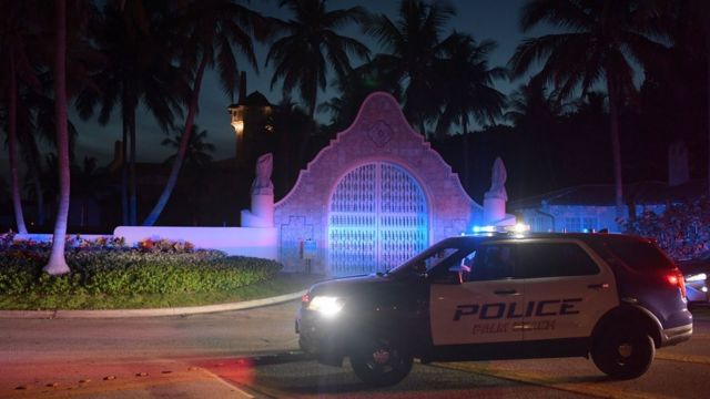 A police car stands guard outside the Mar-a-Lago estate on August 8