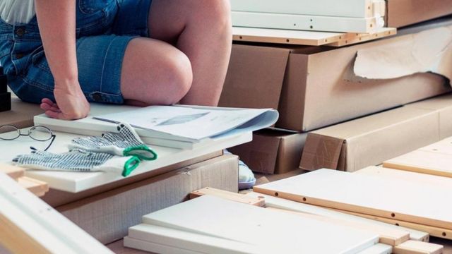 Manual de instrução ao lado de caixas de papelão