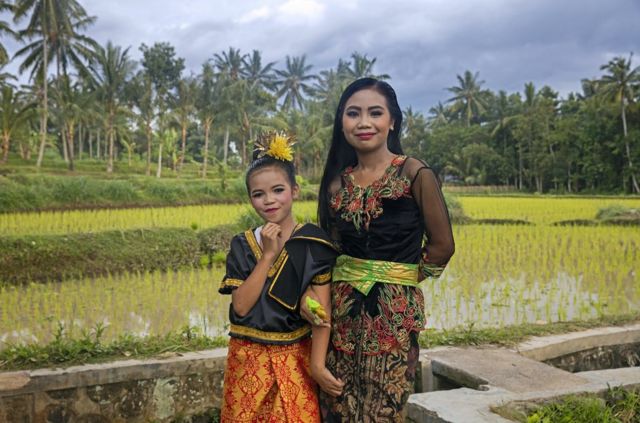 印尼语是从马来语演变而来的，马来语是19世纪的水手跨越东南亚海洋活动的通用语（印尼龙目岛上身穿传统服装的年轻妇女和女孩）。