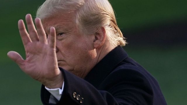 Donald Trump walks near the White House.