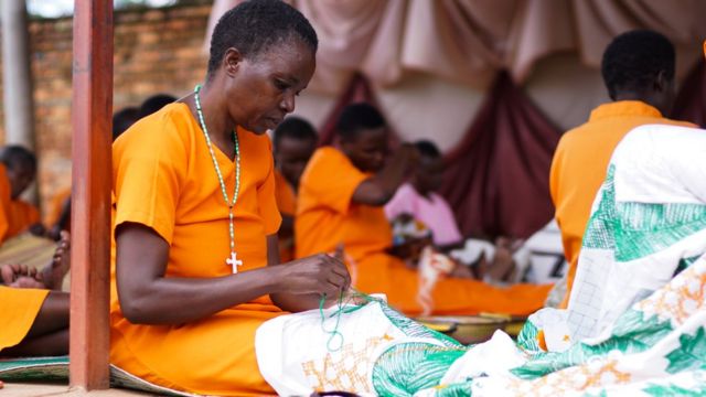 A woman in prison sewing
