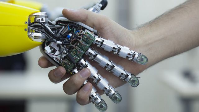 Man shaking robot hand