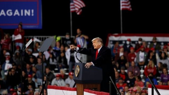 President Donald Trump gestures during a campaign event in Fayetteville, Arkansas