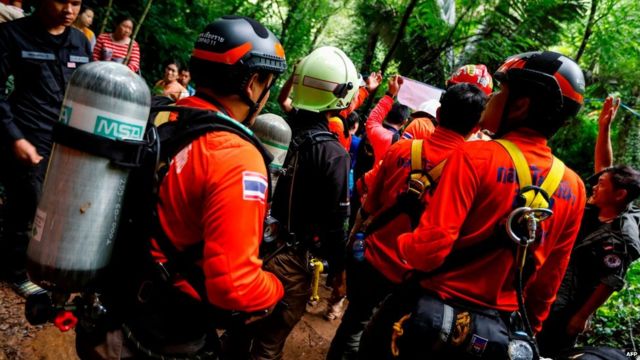 Navy divers assemble in the forest to conduct a search for a group trapped inside a Thai cave
