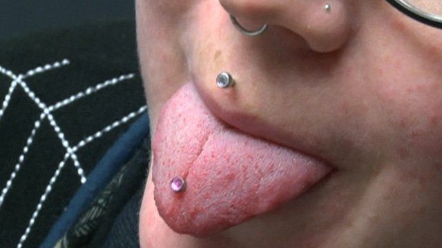 a woman with her tongue pierced
