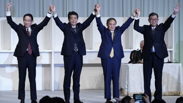Yoshihide Suga (third from left) celebrates after winning the party leadership
