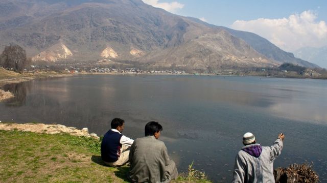 Residents sit on the bank of Manasbal Lake in Manasbal, 20 Km (18 miles) north of Srinagar, the summer capital of Indian administered Kashmir, India. Manasbal lake is one of the deepest lakes in the Kashmir valley.