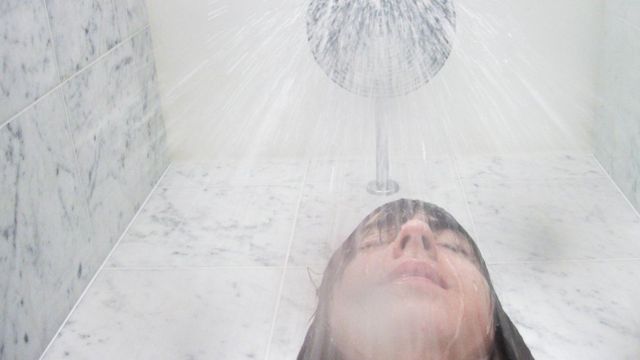 Woman under the shower head