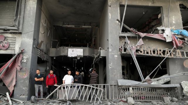 Palestinians surveying damage in May 2021