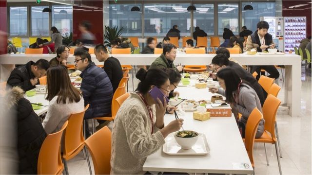 Employees take their lunch in a canteen at JD.com's headquarters in Beijing, China, on Monday, Nov. 30, 2015. JD.com is China's second largest online retailer and is locked in a fierce battle with rival Alibaba.