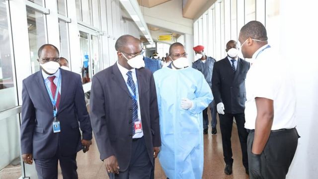 Cameroon Health Minister and oda officials dey check screening process for airport.