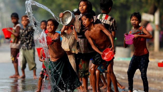 Children play with water during Water Festival outside Mandalay, April 13, 2017.