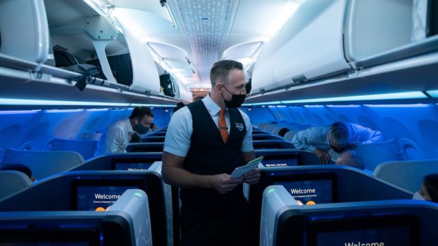 Aircrew talking with passengers on a JetBlue flight from John F. Kennedy International Airport in the United States to London, United Kingdom (11/8/2021)