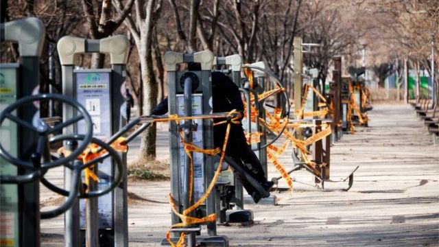 A man tries to use an outdoor gym which has been cordoned off as part of measures to avoid the spread of the coronavirus disease (COVID-19) at a park in Seoul, South Korea, December 30,