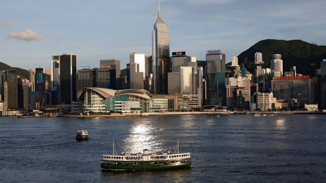 FILE PHOTO: A Star Ferry boat crosses Victoria Harbour in front of a skyline of buildings in Hong Kong, China June 29, 2020