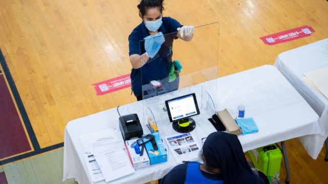 A worker cleans an election station during early voting for the 2 June primary in Washington DC