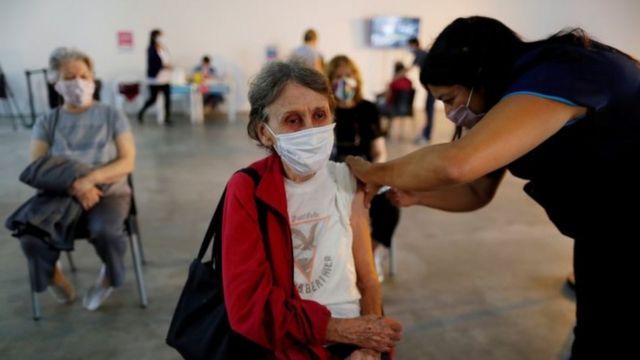 A woman receives a dose of the Sputnik V (Gam-COVID-Vac) vaccine against the coronavirus disease (COVID-19) at the Tecnopolis Park, in Buenos Aires, Argentina April 15, 2021