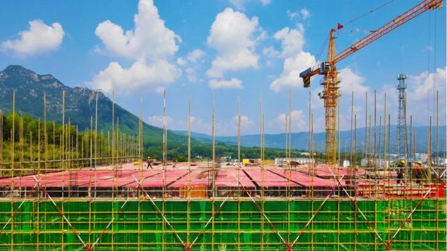 Workers build a factory in the Economic development zone of Yuexi County, Anqing City, Anhui Province, China, Aug 12, 2023.