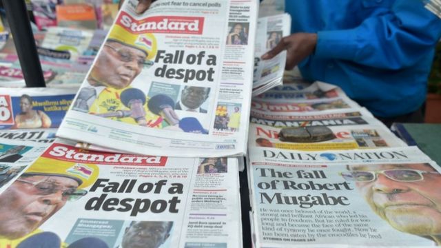 A newspaper vendor arranges local dailies with headlines about the situation in Zimbabwe on November in Nairobi
