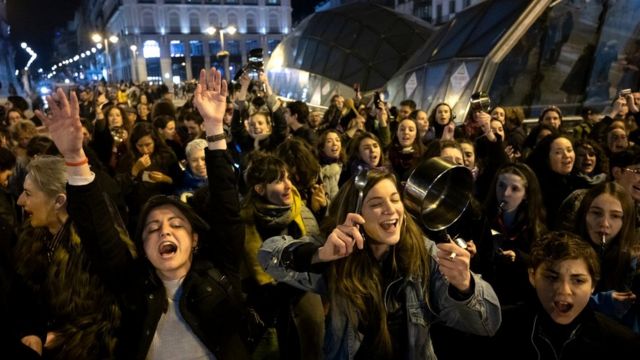 Women in Spain shout and make noise by hitting pots and pans as they mark the start of the International Women's Day in Sol Square, 8 March 2020