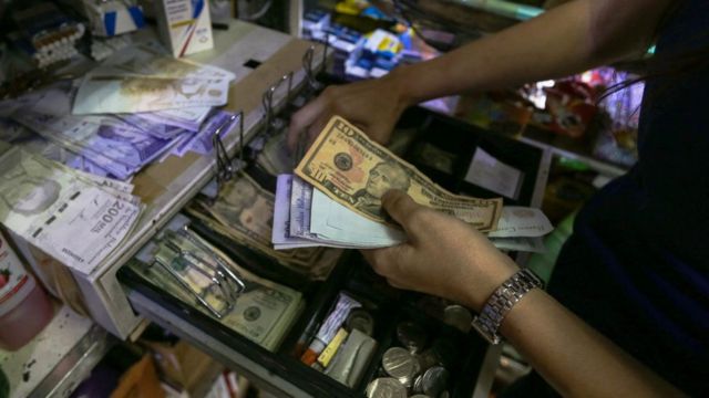 In a business in Venezuela they keep dollar bills in a cash register.