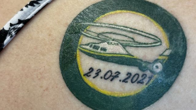 Close of up the tattoo depicting the Great North Airt Ambulance and the date she took ill