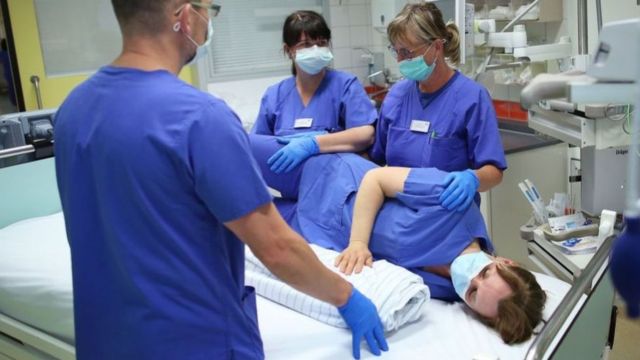 A German medical team practices the proning technique