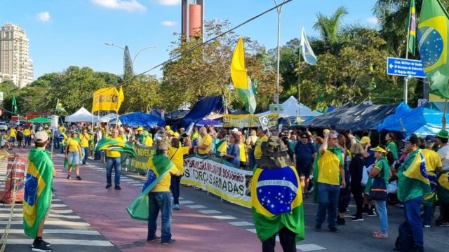Bolsonaro supporters with Brazilian flags and shirts camp in front of the Southeast Military Command in Sao Paulo.