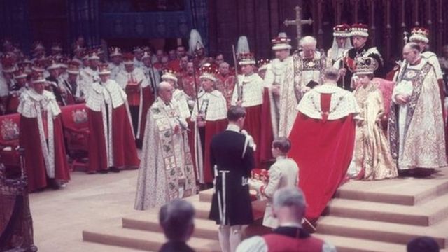The Duke of Edinburgh pays homage to his wife, the newly crowned Queen Elizabeth II, during her coronation ceremony, 1953