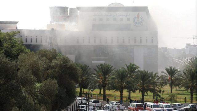 Smoke rises form the headquarters of Libyan state oil firm National Oil Corporation (NOC) on 10 September 2018