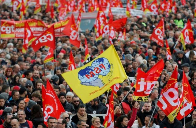 French Labour union members hold flags at a demonstration in Marseille