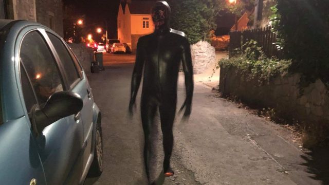 Man in 'gimp suit' jumps in front of woman's car in Bleadon - BBC News