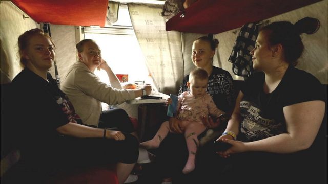 Viktoria, 20, with her young child Eva, on a train to the Ukrainian town of Pokrovsk