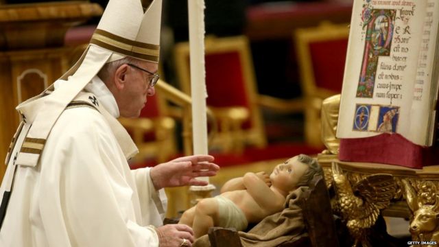 Pope Francis takes the Baby Jesus as he leaves Christmas Eve Mass at St. Peter's Basilica on December 24, 2018 in Vatican City, Vatican