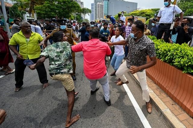 Demonstrators and government supporters clash outside the official residence of Sri Lanka's Prime Minister Mahinda Rajapaksa