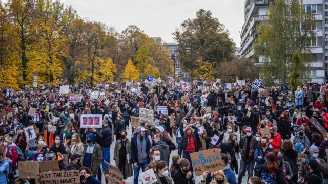 People shout slogans and hold banners as they participate in a national strike during the seventh day of protests against the Constitutional Court ruling