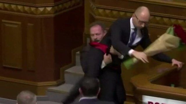 Prime Minister Yatseniuk is lifted up in the Ukrainian parliament