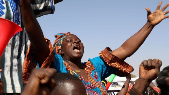 Umugore ugaragaza imbamutima ze, ubwo imbaga yari yateranye mu gushyigikira ihirikwa rya Perezida Roch Christian Kaboré, iseswa rya guverinoma, guhagarika itegekonshinga no gufunga imipaka byakozwe n'igisirikare, aha ni mu murwa mukuru Ouagadougou wa Burkina Faso, ku itariki ya 25 y'ukwezi kwa mbere mu 2022.