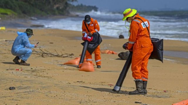UK-based Oil Spill Response experts look for pollutants from the Singapore-registered container ship MV X-Press Pearl, which is sinking after burning for almost two weeks in the sea off Colombo Harbour, at Sarakkuwa beach, north of Sri Lankas capital Colombo on June 10, 2021.
