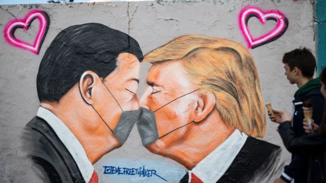 Graffiti showing Xi Jinping and Donald Trump kissing in face masks