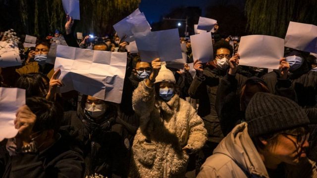 Demonstrators in Beijing hold blank papers