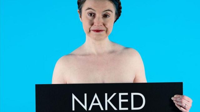 Victoria Bateman holding a banner which reads naked 
